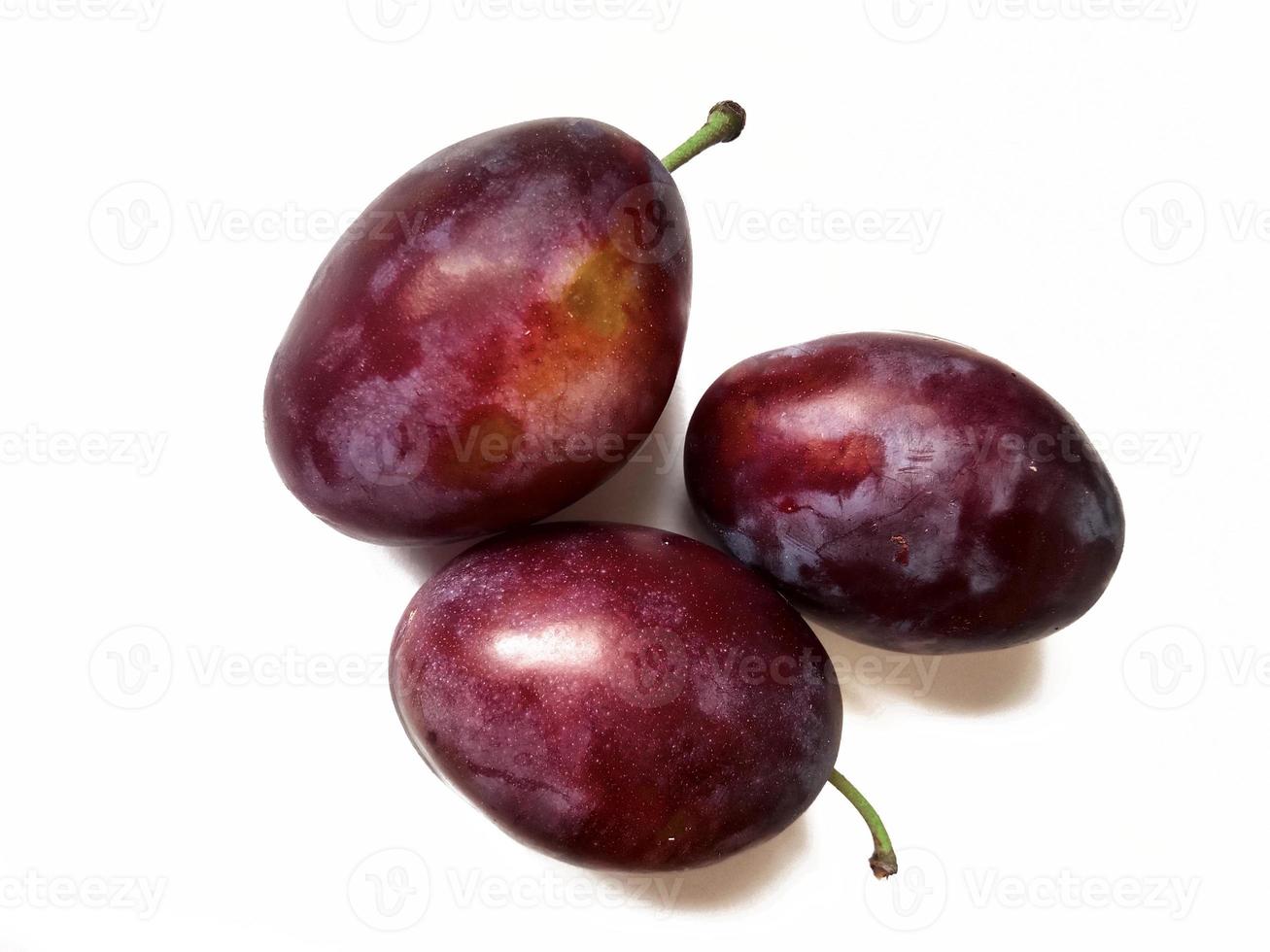 ripe juicy plums on white background photo