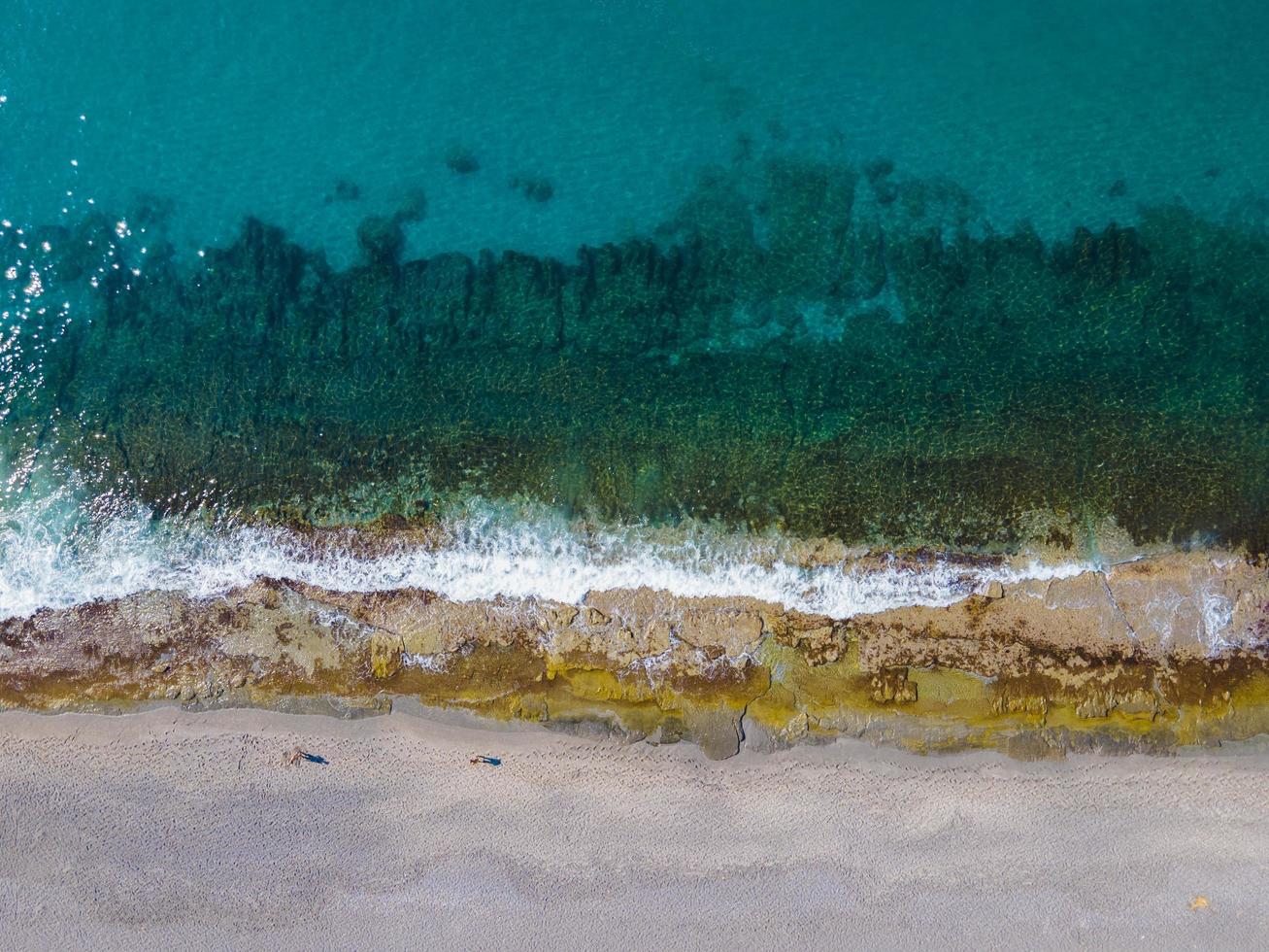 Sea Aerial view, Top view, amazing nature background. Water color and beautiful bright. Rocky shore and clear water of the sea on a sunny day Flying drone, seascape photo
