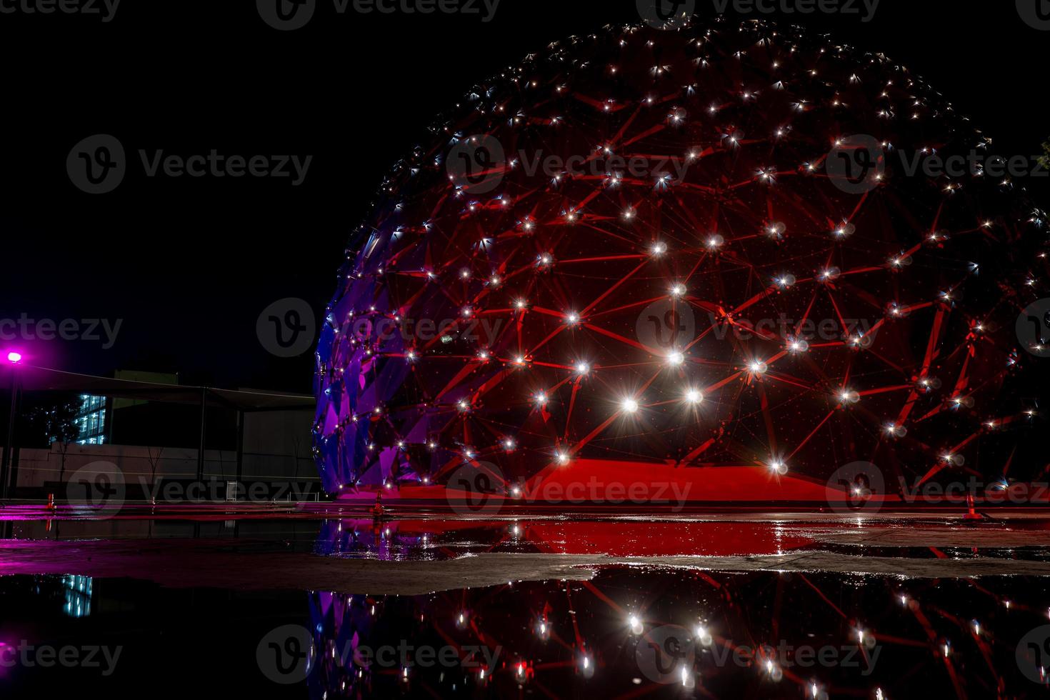 dome shaped building, with colored lights, reflection in water, parametric skin mexico photo