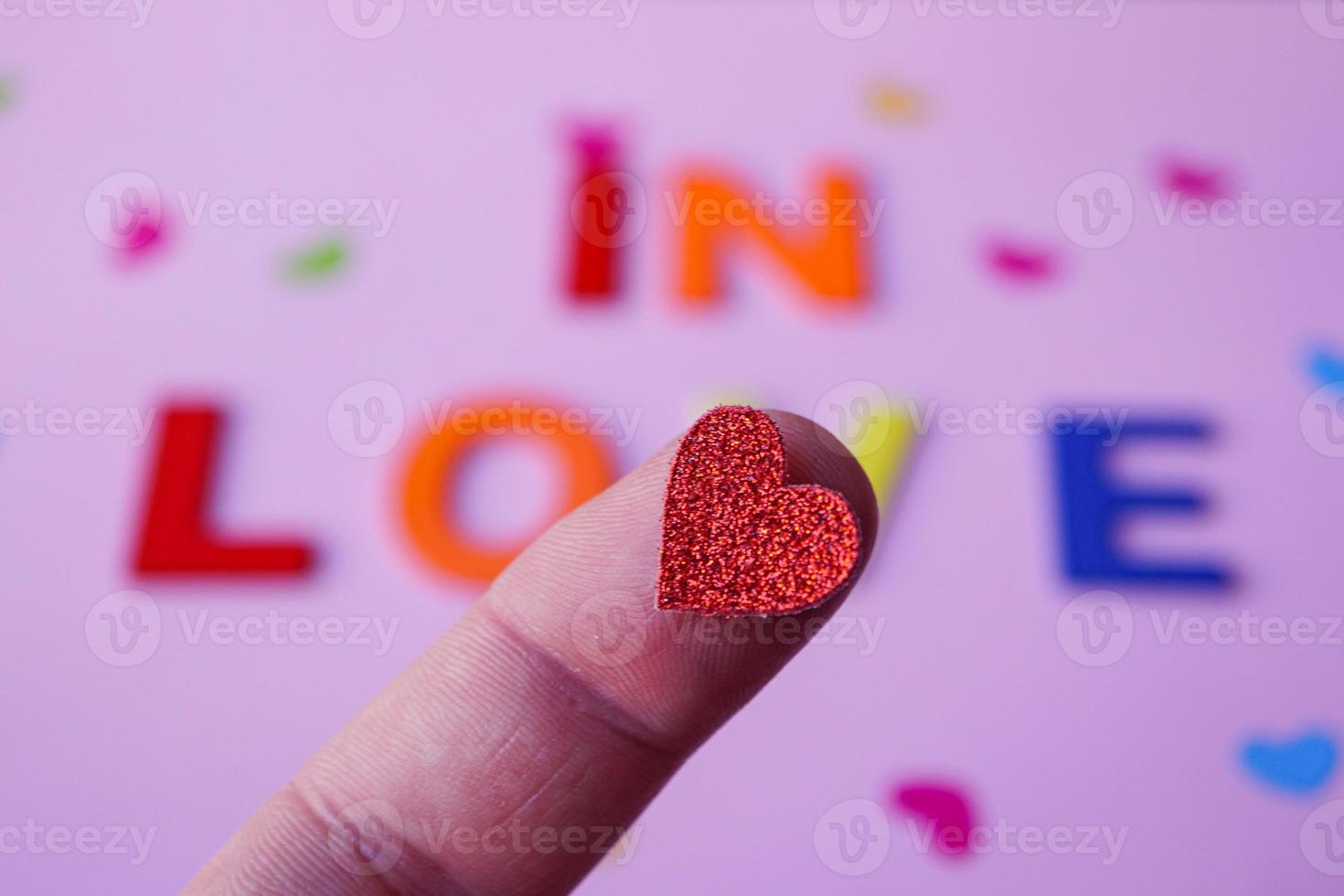 in love word with wooden letters on the pink background, valentine's day photo