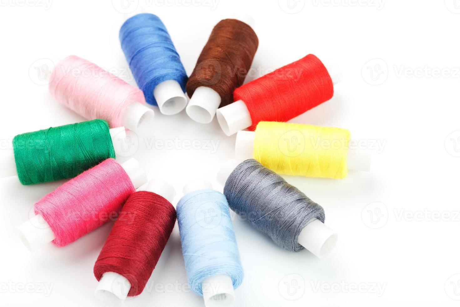 Colorful cotton craft sewing threads in flower shape isolated on white background. photo