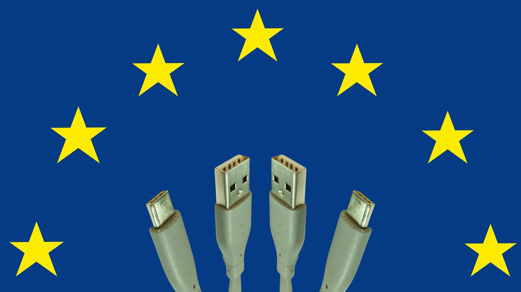 illustration Concept of European Union law to force USB-C charger for all mobile phones. EU flag and USBC universal charging cable. Selective focus. photo