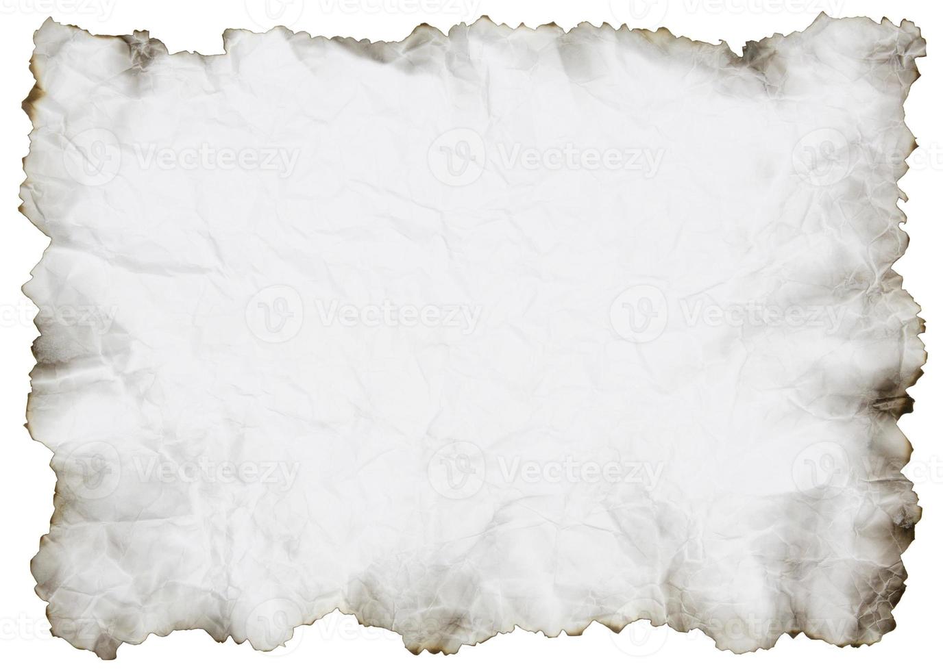 crumpled paper with burnt edges over white photo