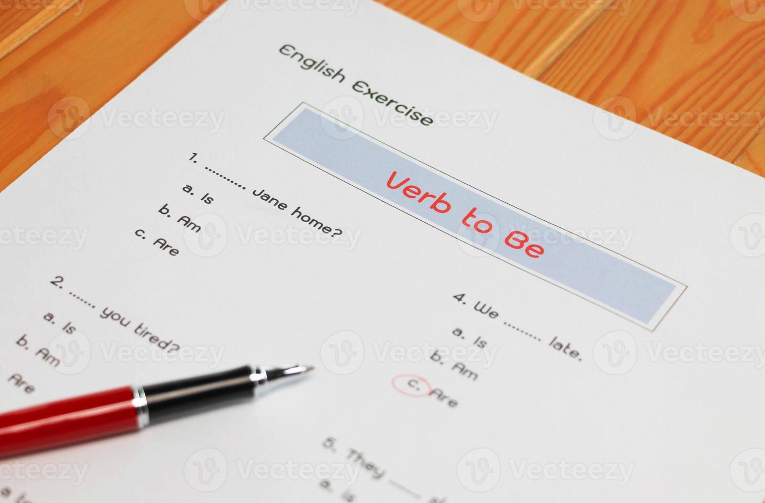 English grammar test sheet on wooden table photo