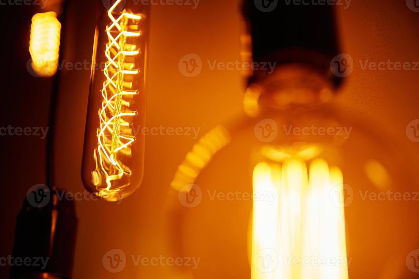 Set of a vintage light bulb on orange background, soft focus. photo