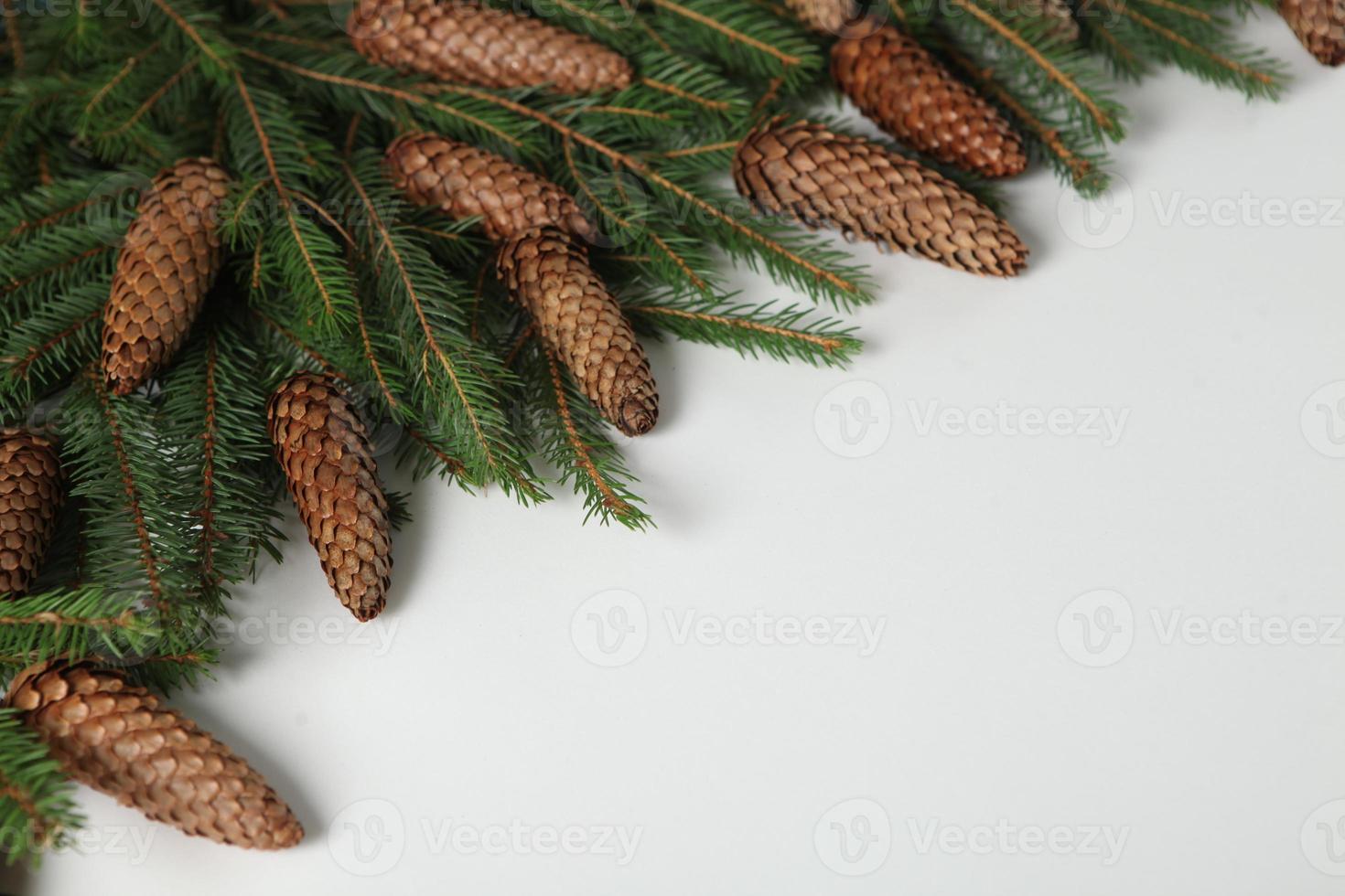 New Year's Eve background with fir branch and cones. Christmas and New Year holidays composition of pine tree branches. photo