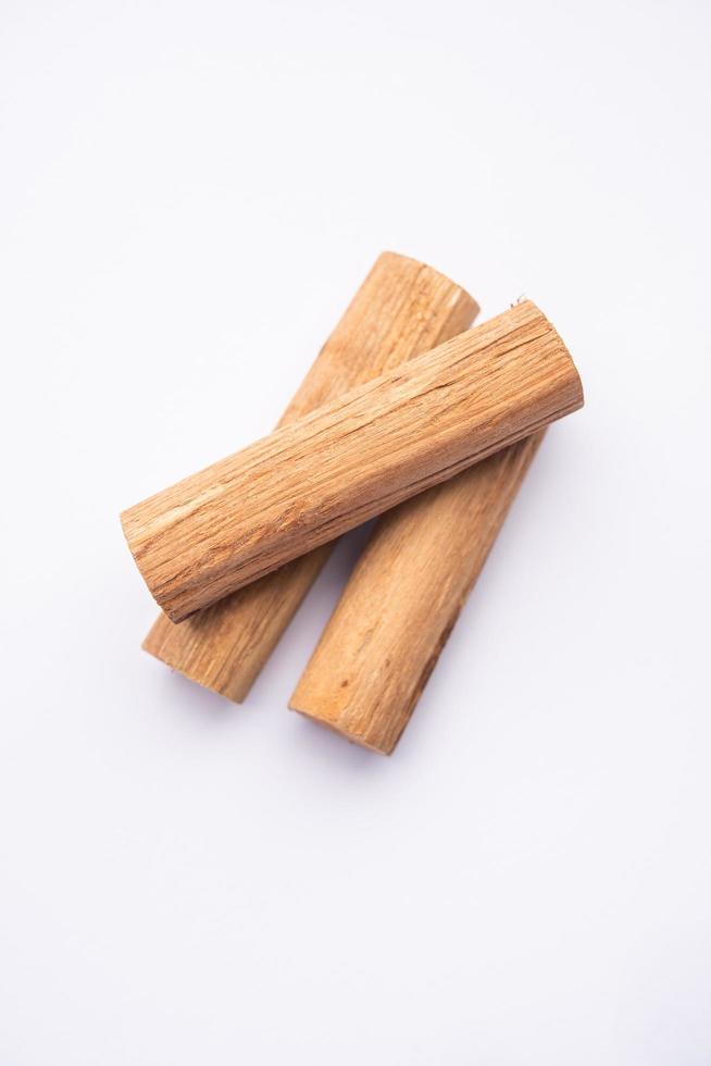 Chandan or sandalwood powder with sticks, perfume or oil which retain their fragrance for decades photo