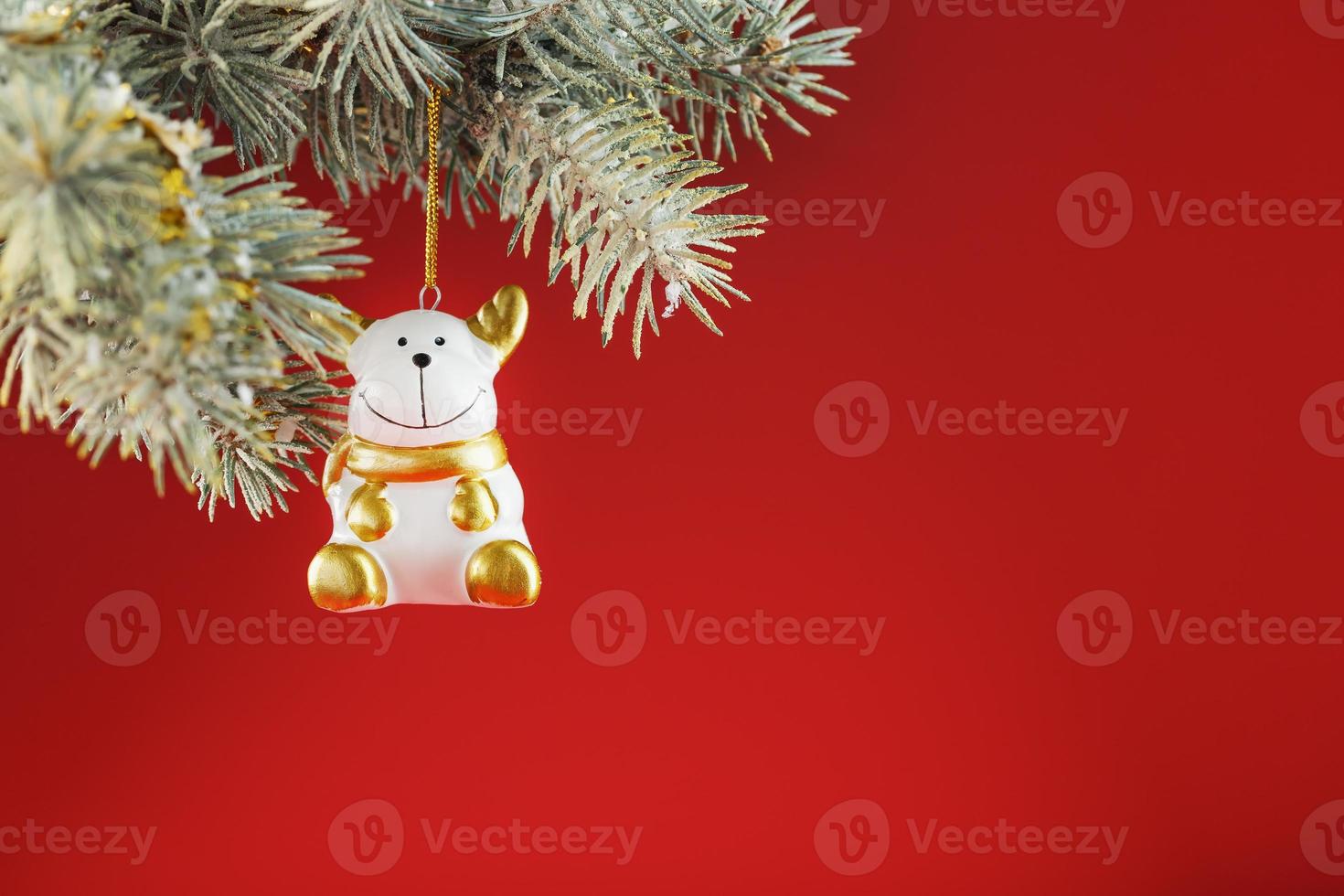 Bull figure on a Christmas tree on a red background, free space for text. photo