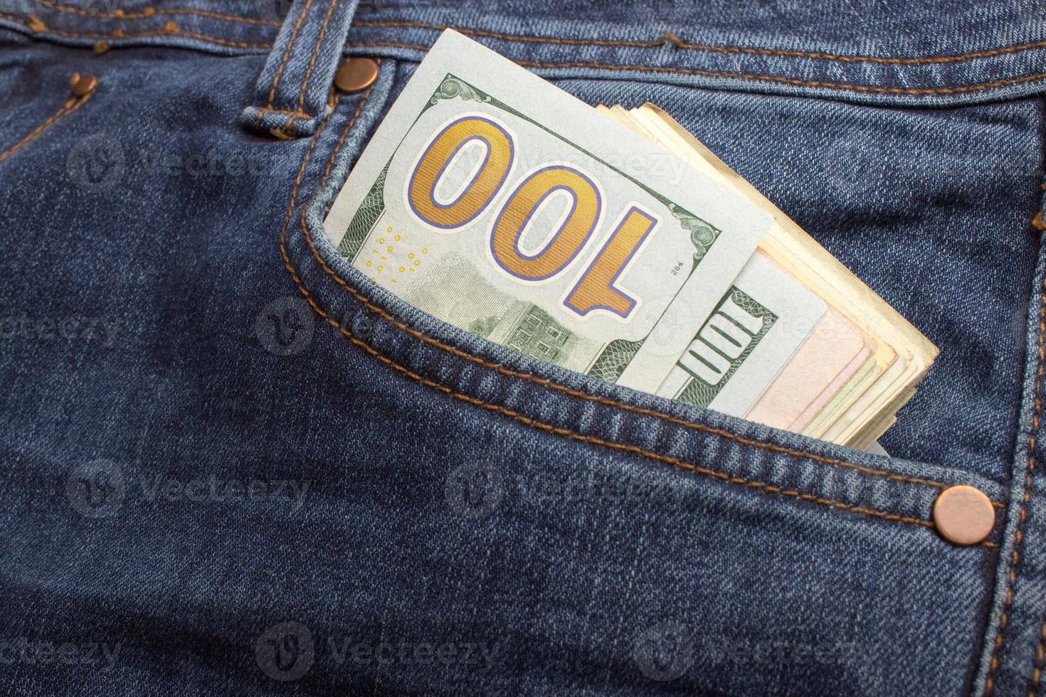 American dollar bills in jeans pocket background photo