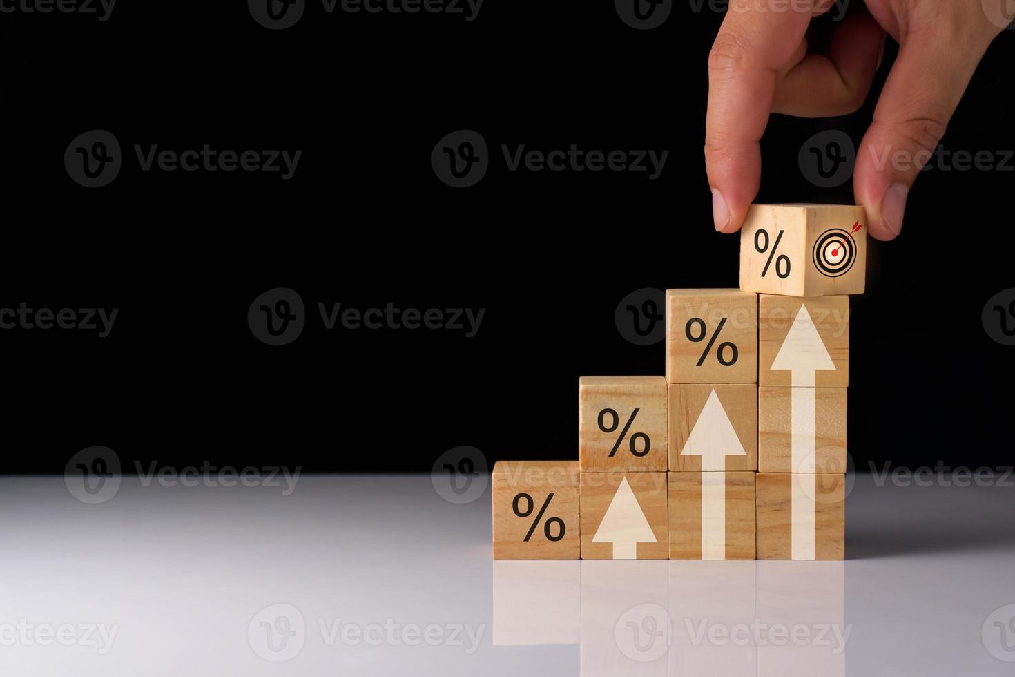 wooden cube planning to invest in stock market. wooden cube success goals icon on virtual screen, stock graph is rising, economy is recovering, stock trading, bussiness start up, business success. photo