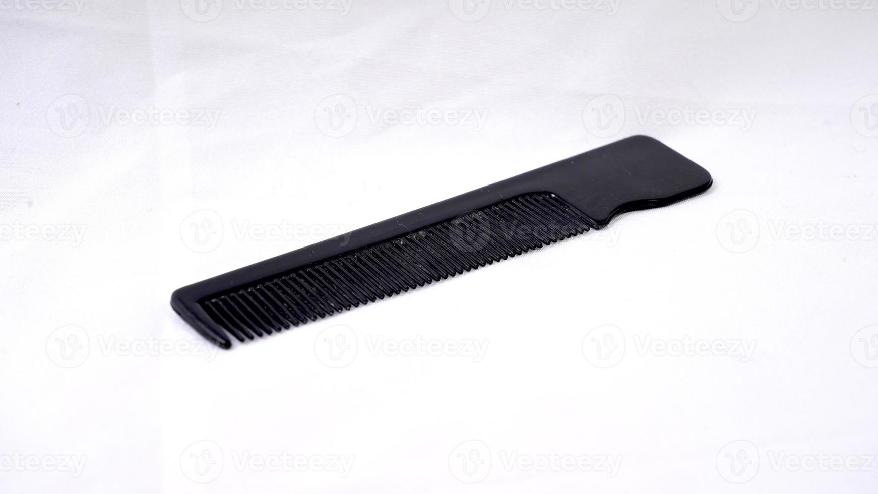 Black comb isolated on a white background. Top view photo