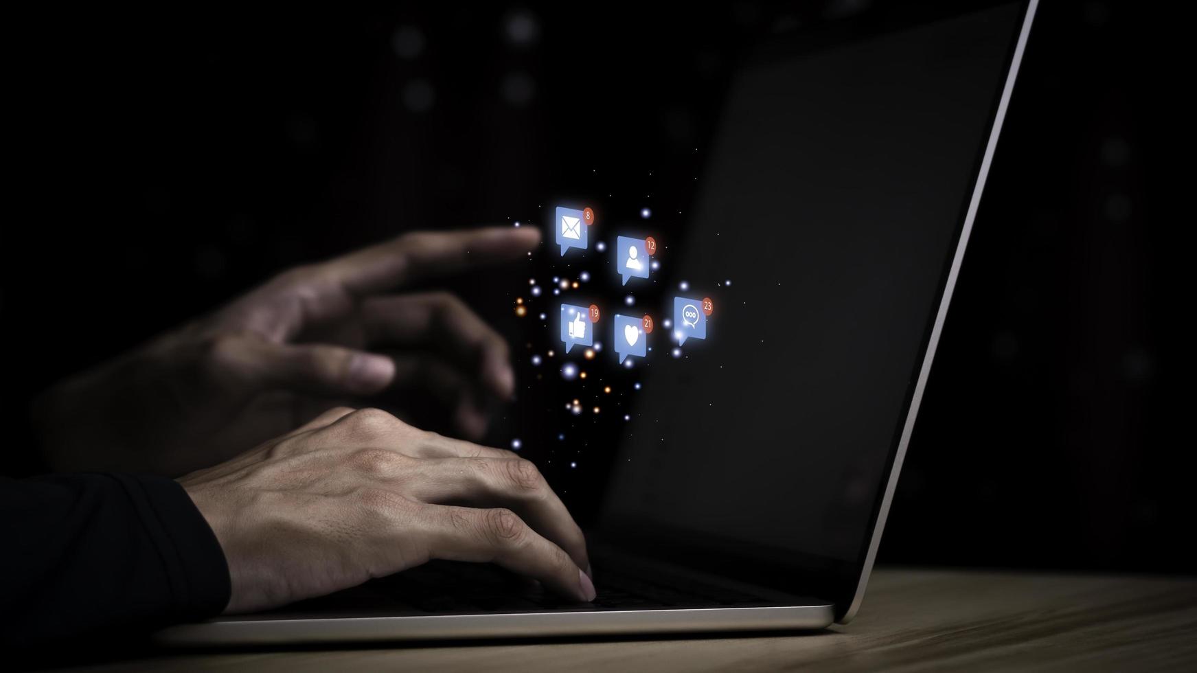 Concept with notification icons of like being happy.and social media interactions on laptop,message, email, comment ,businessman hands holding device,smartphone, internet digital marketing. photo