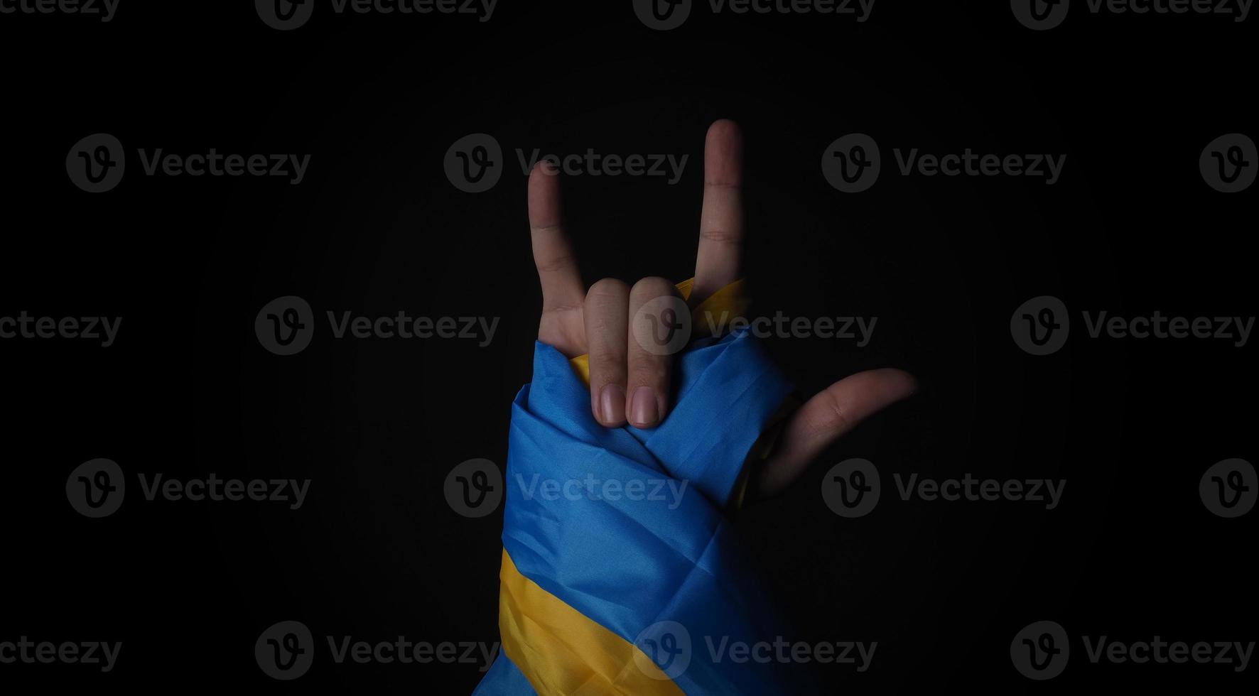 Russian flag and Ukraine flag in hands showing symbol of struggle war photo