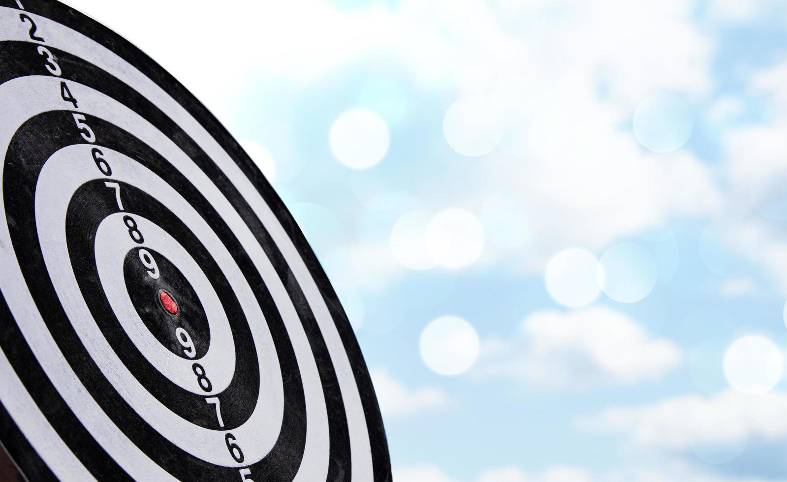 dart arrow hitting in the bullseye center of dartboard. concept of business targeting and aim for business success photo