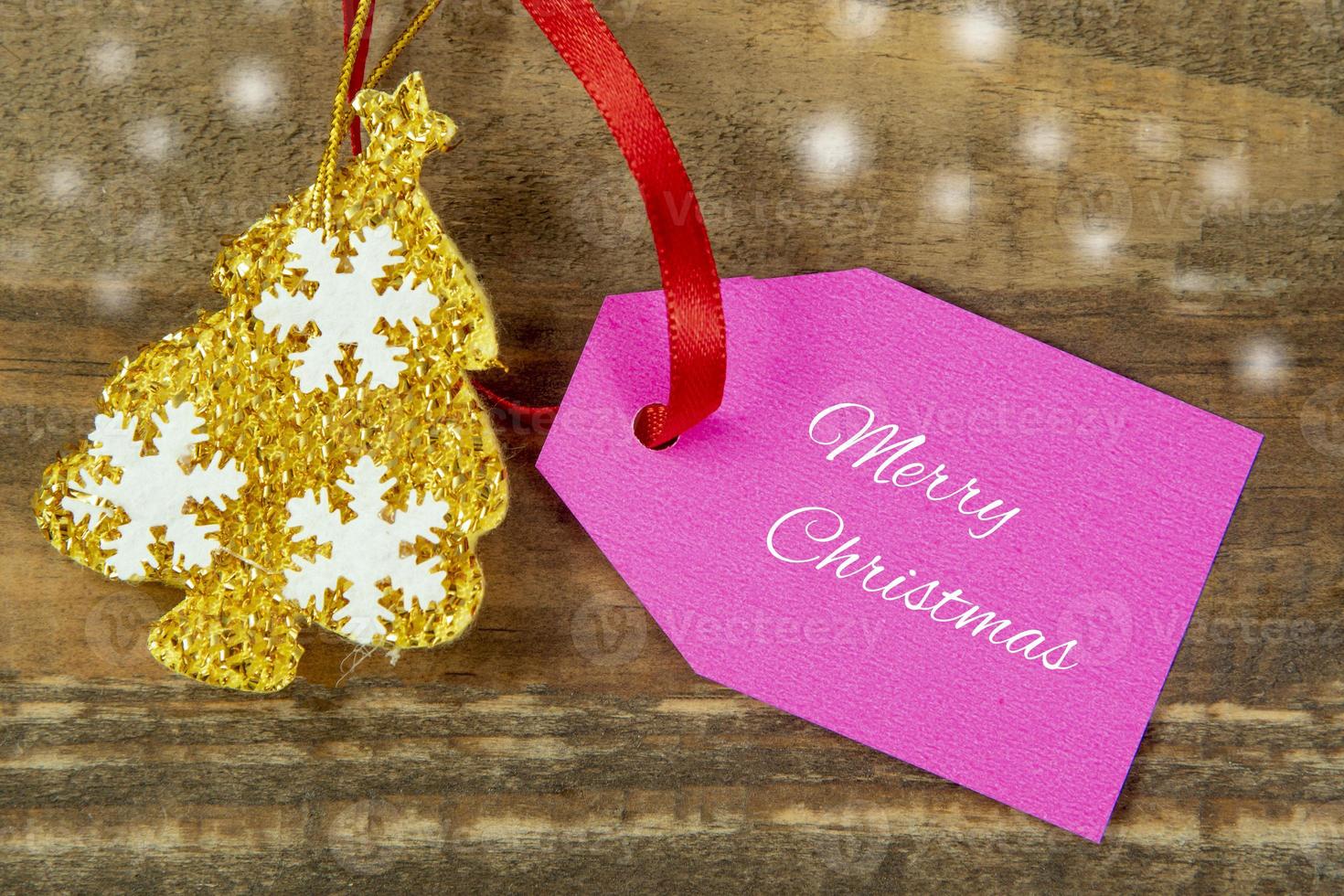 decorative christmas elements next to card with red ribbon and space to write photo