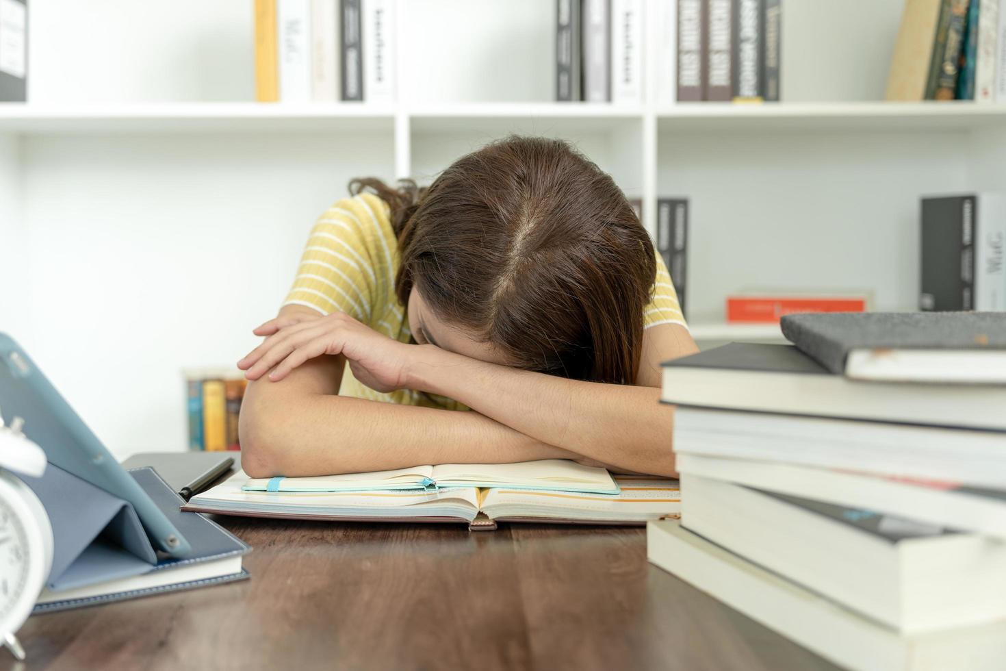 Asian student woman have anxiety because of exams, female prepare for test and learning lessons in the library. stress, despair, haste, misunderstanding reading, discouraged, expectation, knowledge photo