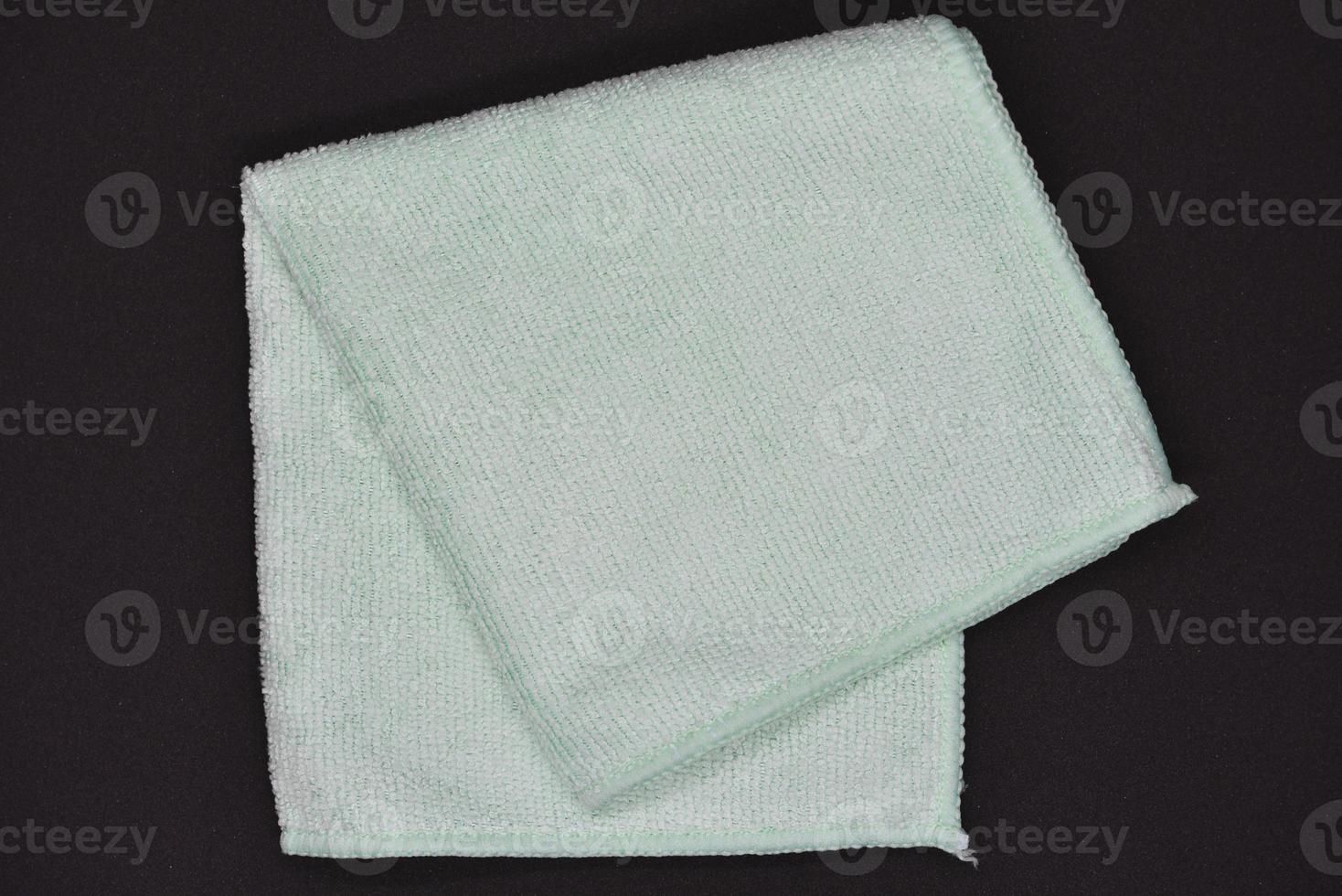 Light blue cloth for wiping.  Towel on a black background. photo