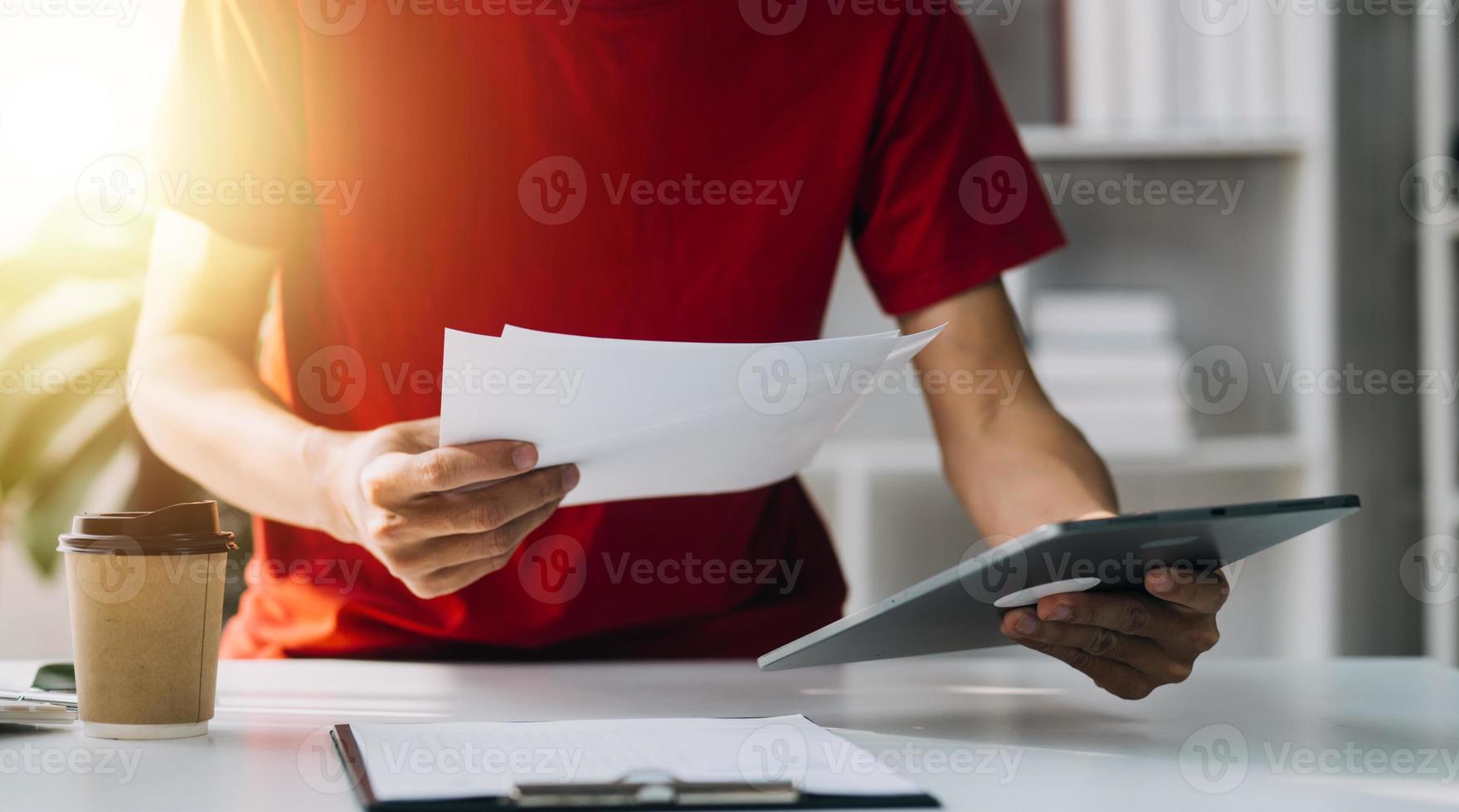 Asian Business woman using calculator and laptop for doing math finance on an office desk, tax, report, accounting, statistics, and analytical research concept photo