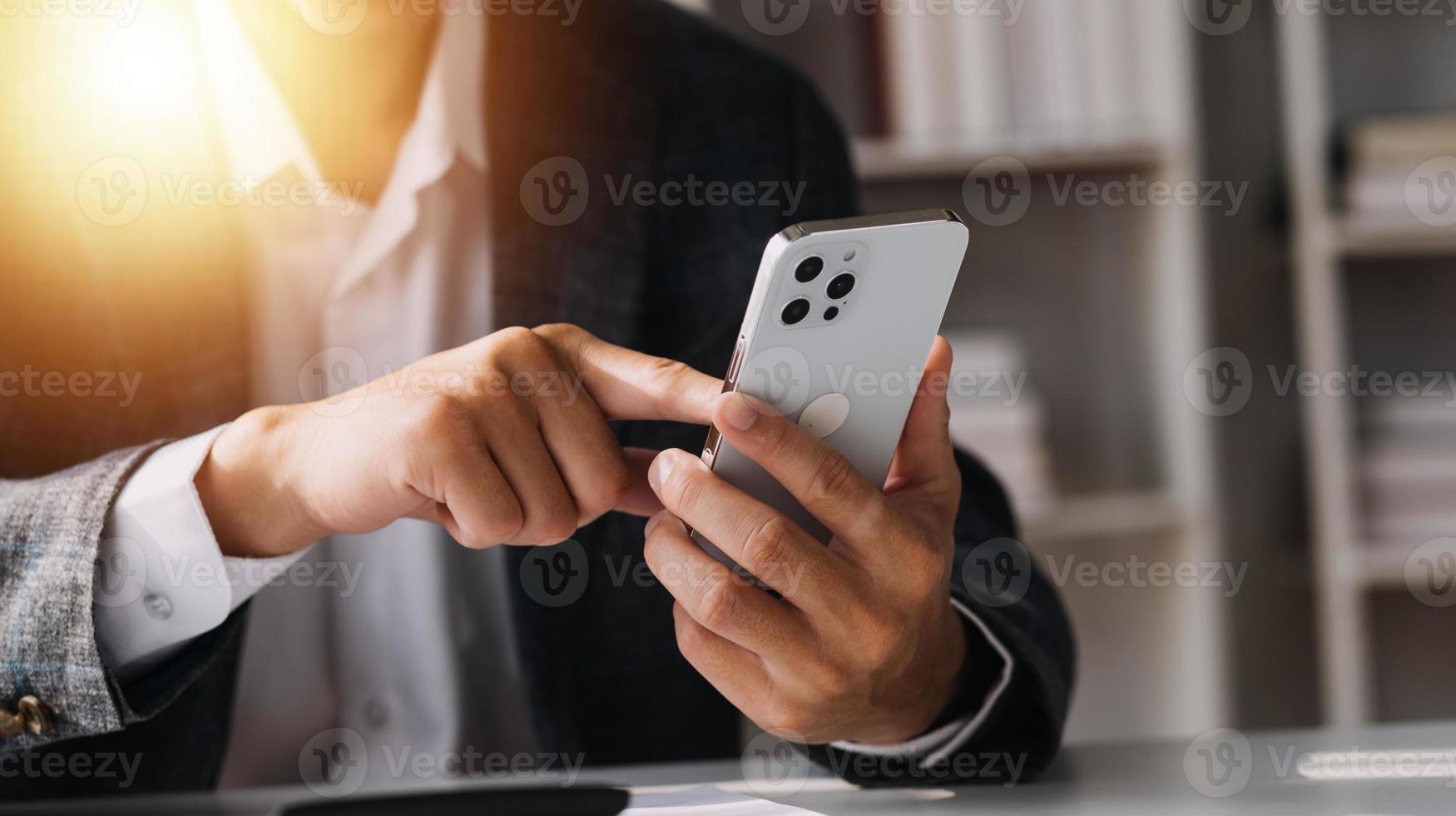 Asian Business woman using calculator and laptop for doing math finance on an office desk, tax, report, accounting, statistics, and analytical research concept photo