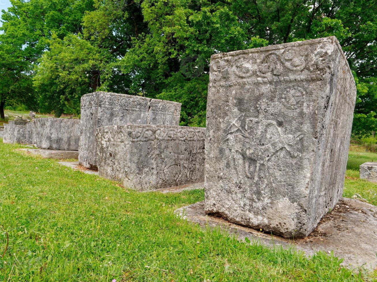 Stecci Medieval Tombstones Graveyards in Boljuni, Bosnia and Herzegovina. Unesco site. Historic place of interest. The tombstones feature a wide range of decorative motifs and inscriptions. photo