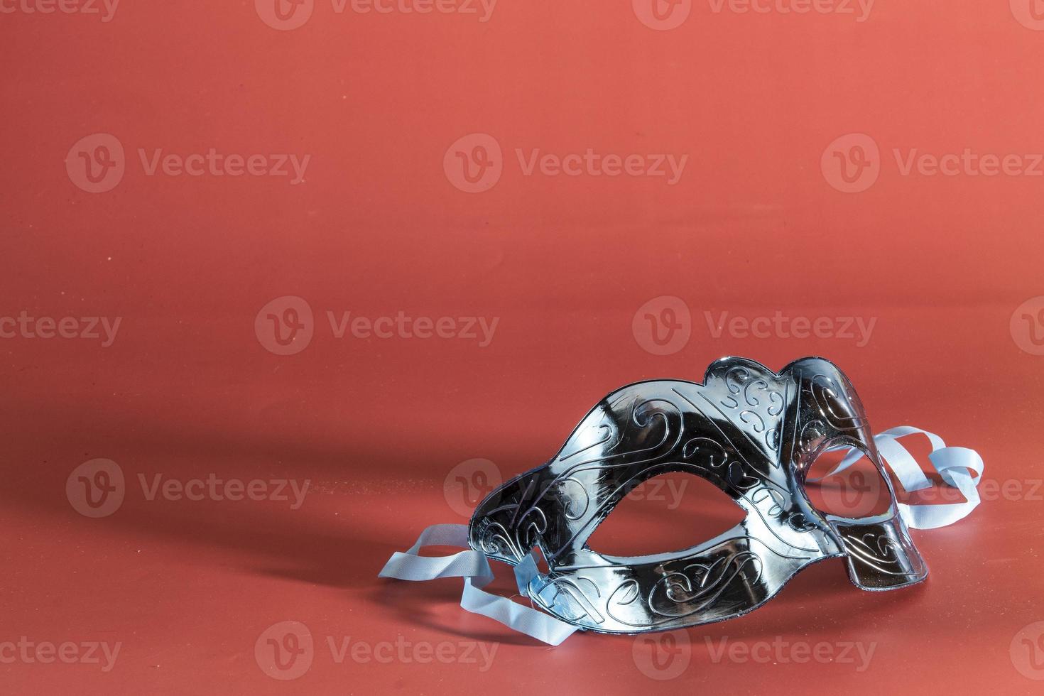 Venetian carnival mask, forming frame in one of the lower corners with space for text photo