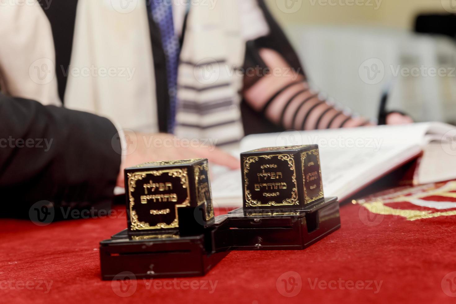 Hand of boy reading the Jewish Torah at Bar Mitzvah photo