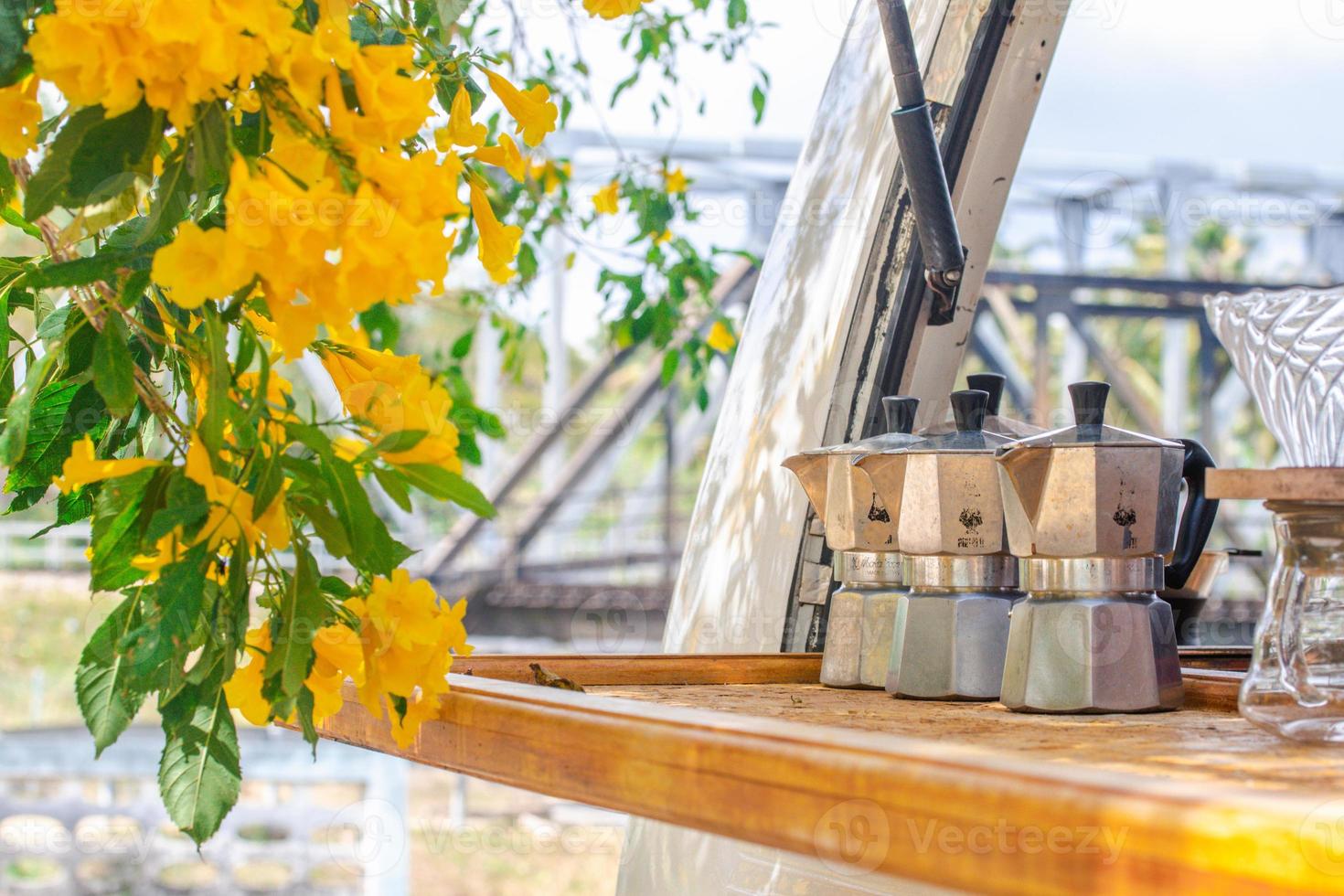 Moka pot, coffee pot laying on the table, nature background photo