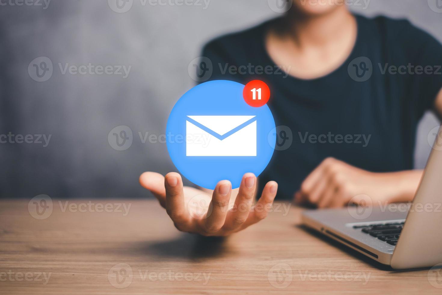 Email marketing concept, Person hand holding email icon on virtual screen, e-mail communication marketing, business newsletter. photo