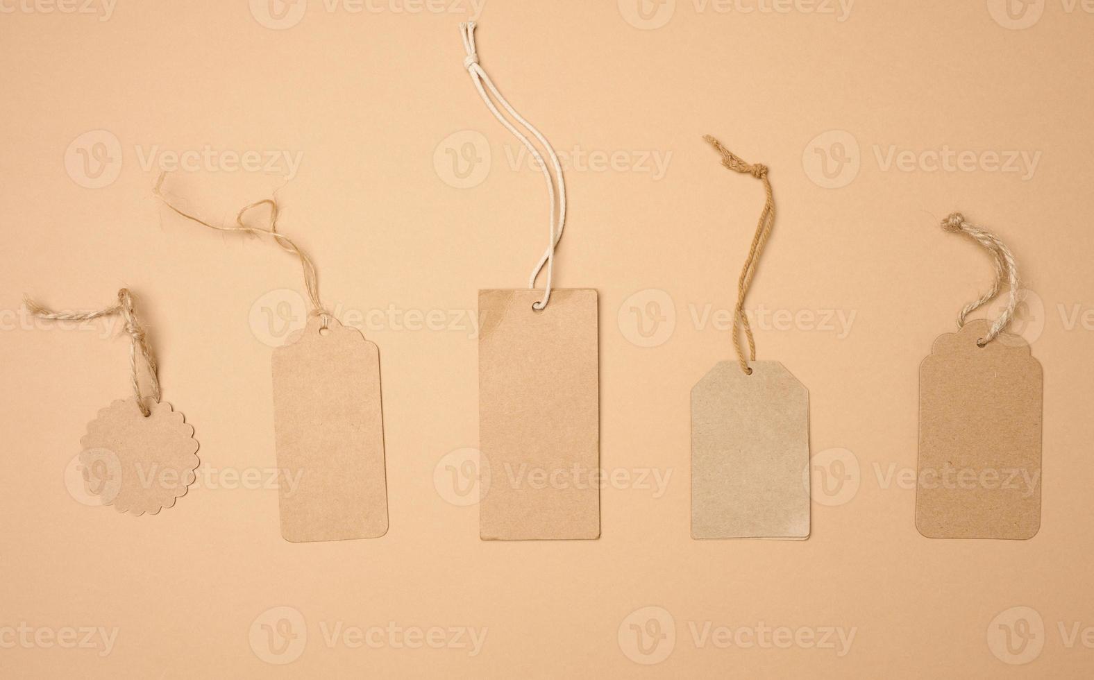 blank brown rectangular, round brown paper tag on a rope isolated on white background, template for price photo