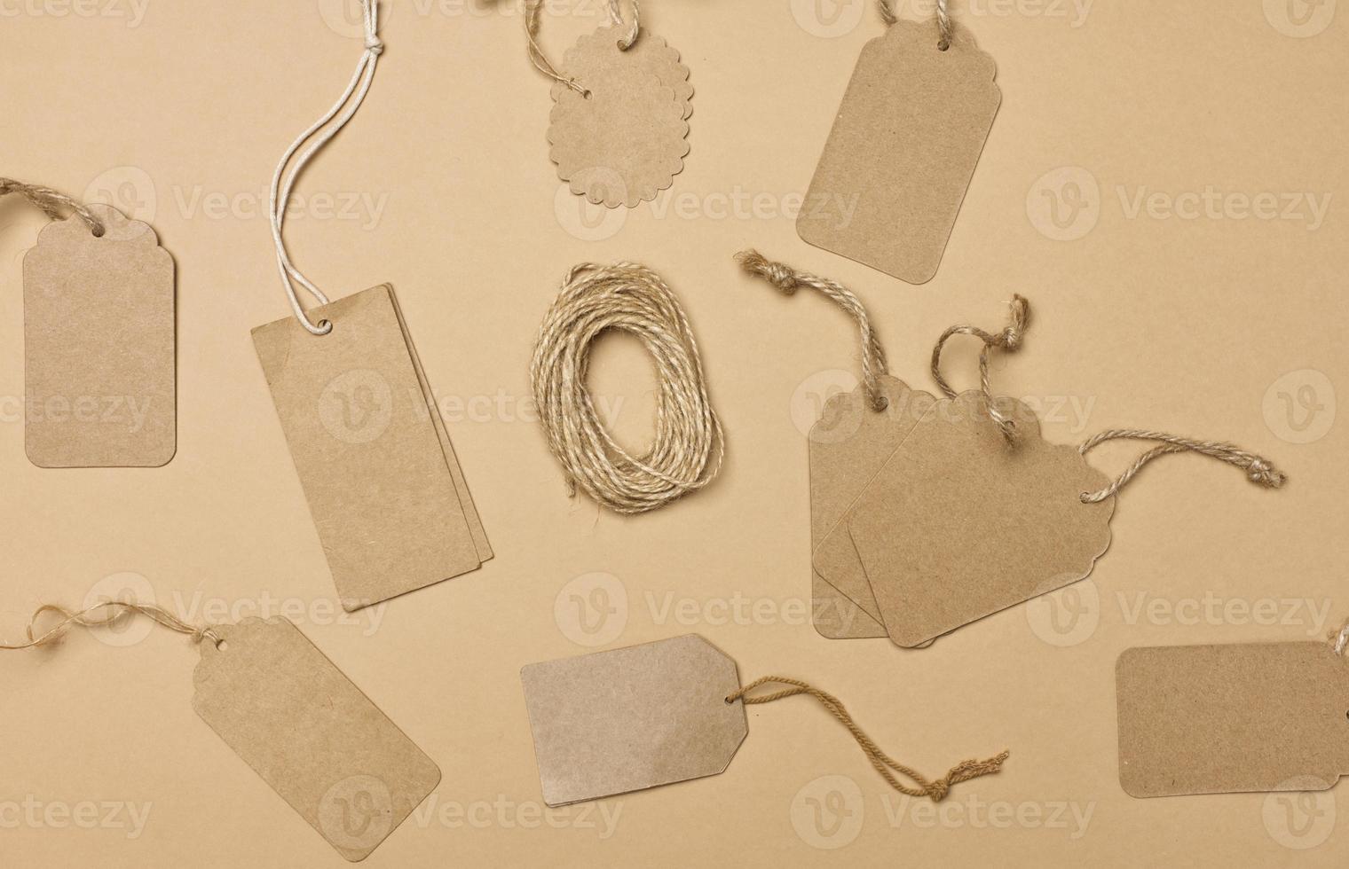 blank brown rectangular, round brown paper tag on a rope isolated on white background, template for price, discount photo