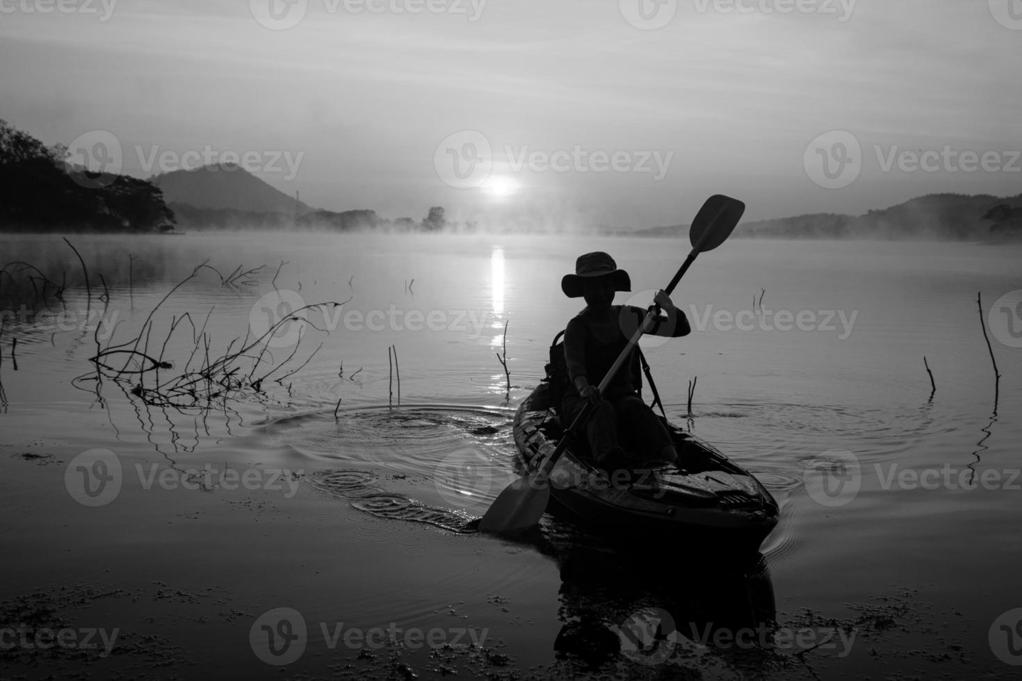 Women on kayak rows in the reservoir during the sunrise, Harirak forest park Huai Nam Man reservoir Loei Thailand 21 Jan 2023 photo