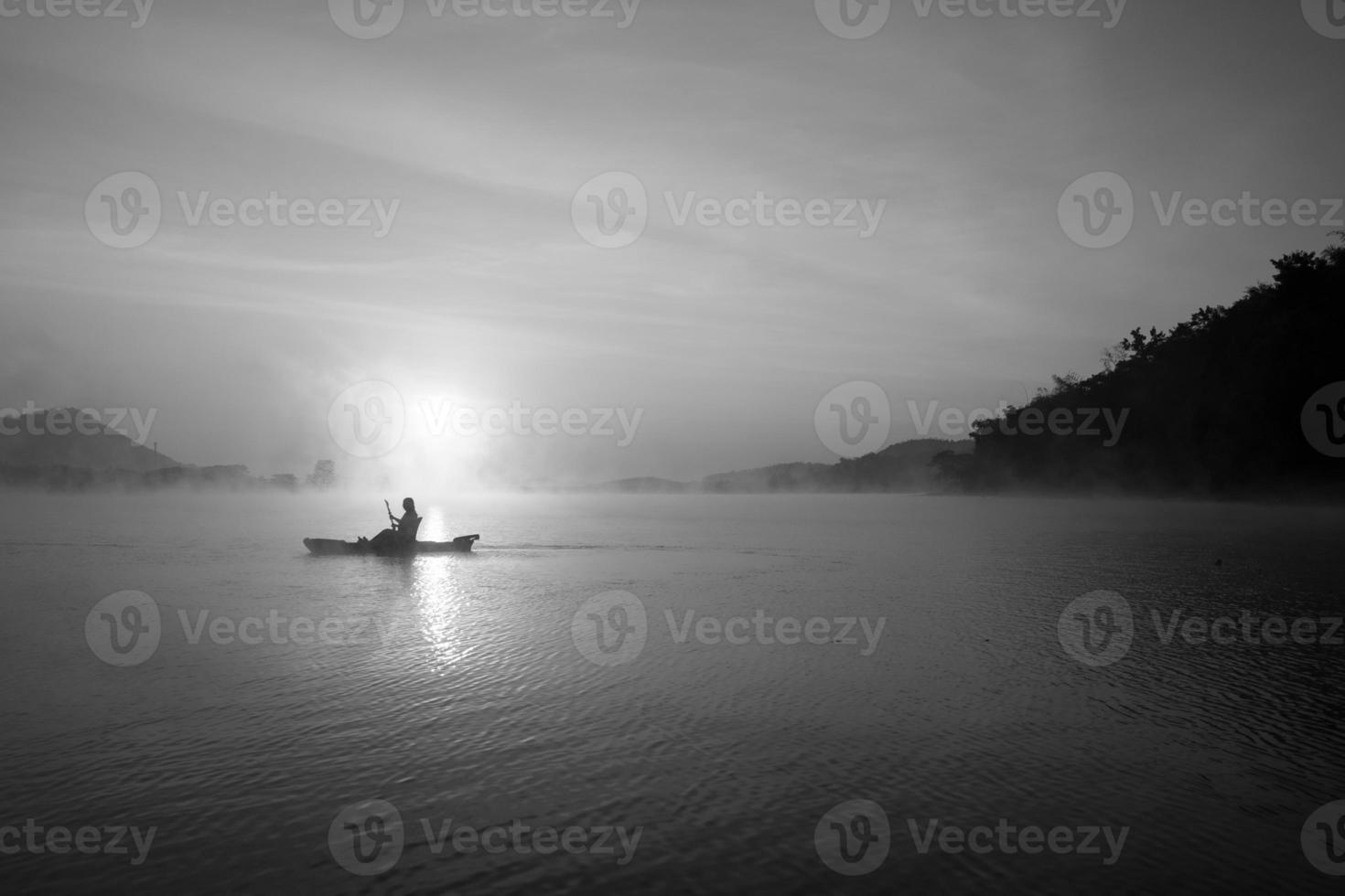 Women on kayak rows in the reservoir during the sunrise, Harirak forest park Huai Nam Man reservoir Loei Thailand 21 Jan 2023 photo