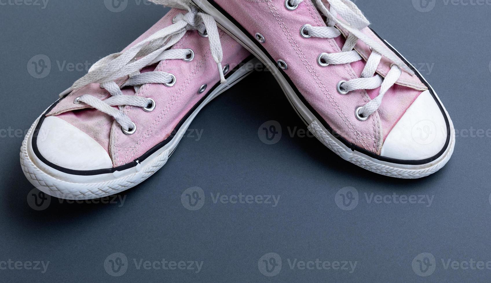 pair of old worn pink sneakers photo