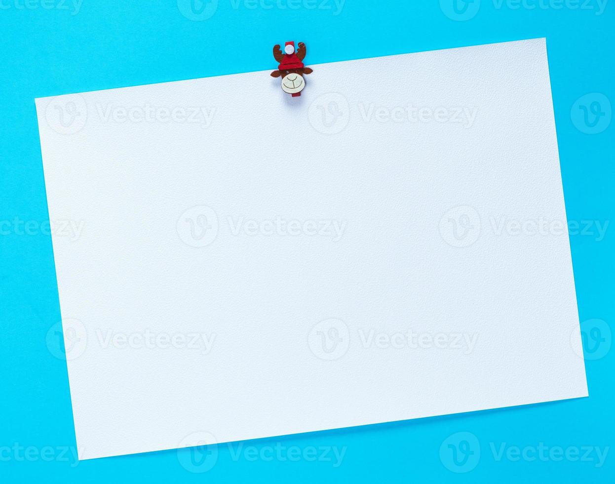 empty white square sheet of paper on a blue background photo