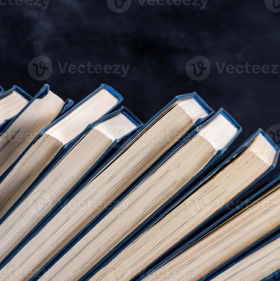 uneven row of books with a blue cover photo