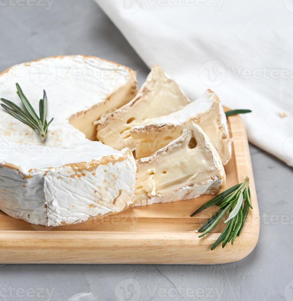 round brie cheese on a wooden board photo