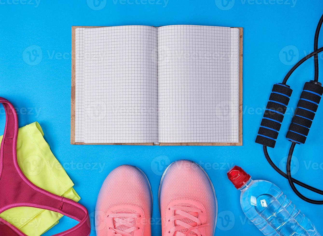 open notebook with empty white sheets, sportswear for fitness photo