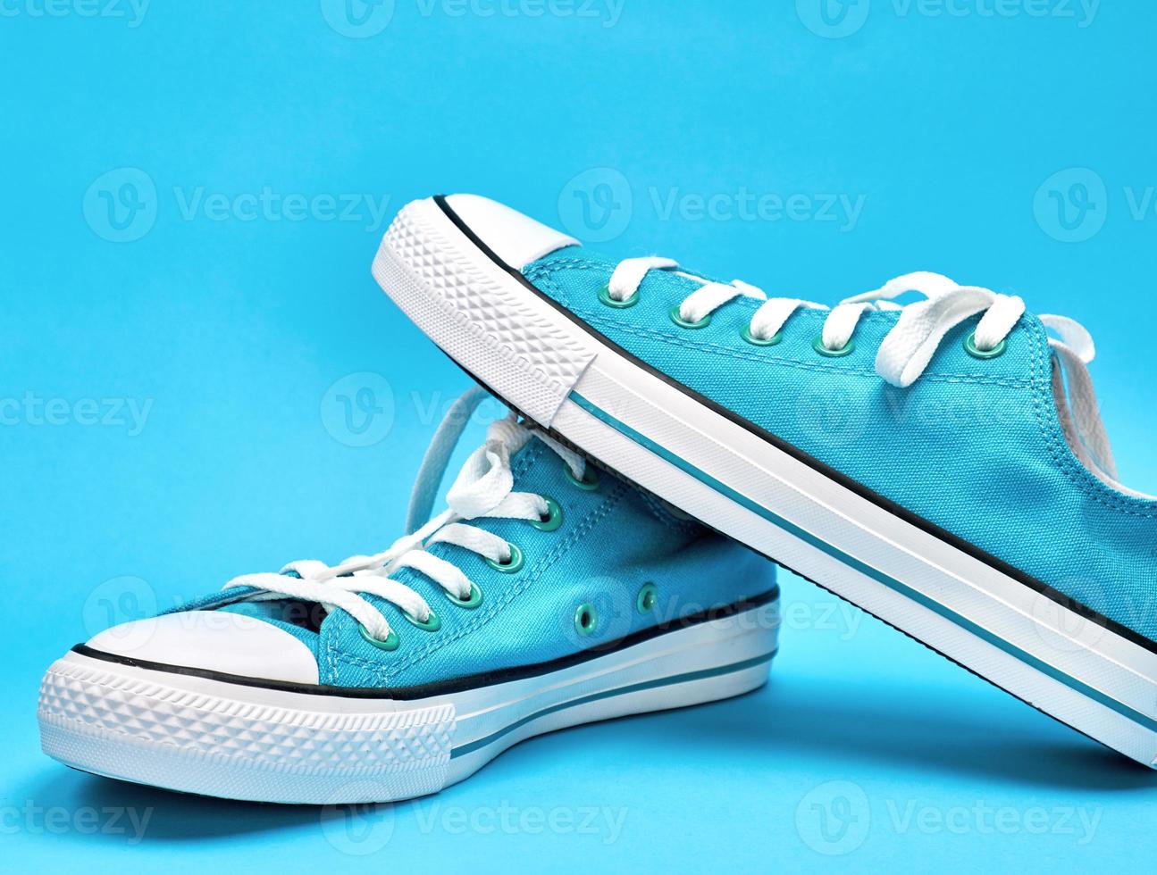 pair of blue textile sneakers with white laces, photo