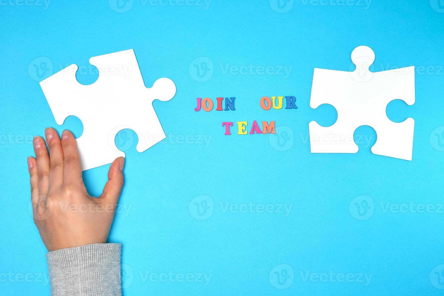 women's hand hold  large white puzzle photo