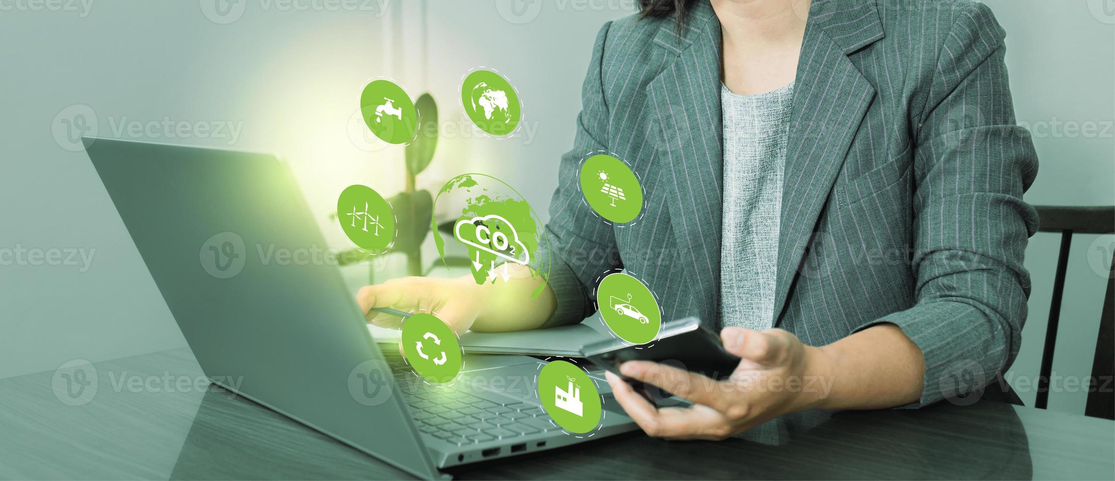 Business woman use computer to analyze Co2, CO2 environmental social governance investment business concept. Co2 icons pop up on the computer screen in business investment strategy concept. photo