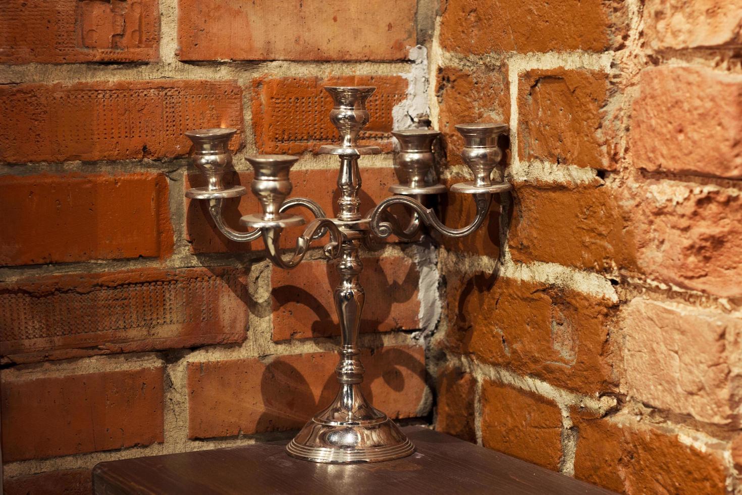 Candelabra candlestick backgrouold red brick wall photo
