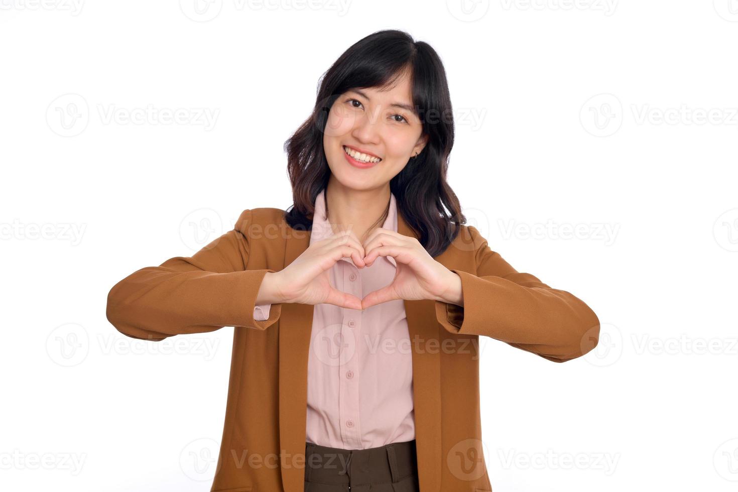 Young asian woman hands making a heart shape on a white isolated background photo