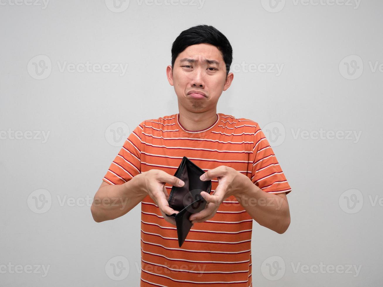 Asian man striped shirt feels sad about no money in his wallet,Poor man concept photo