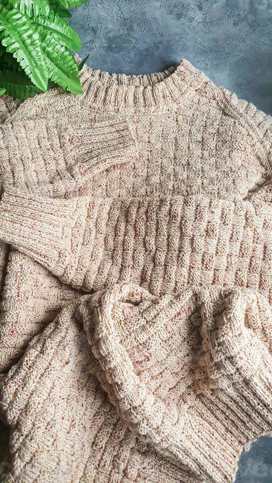Knitted handmade items. Knitted fabric from colored thread. Bright background. photo