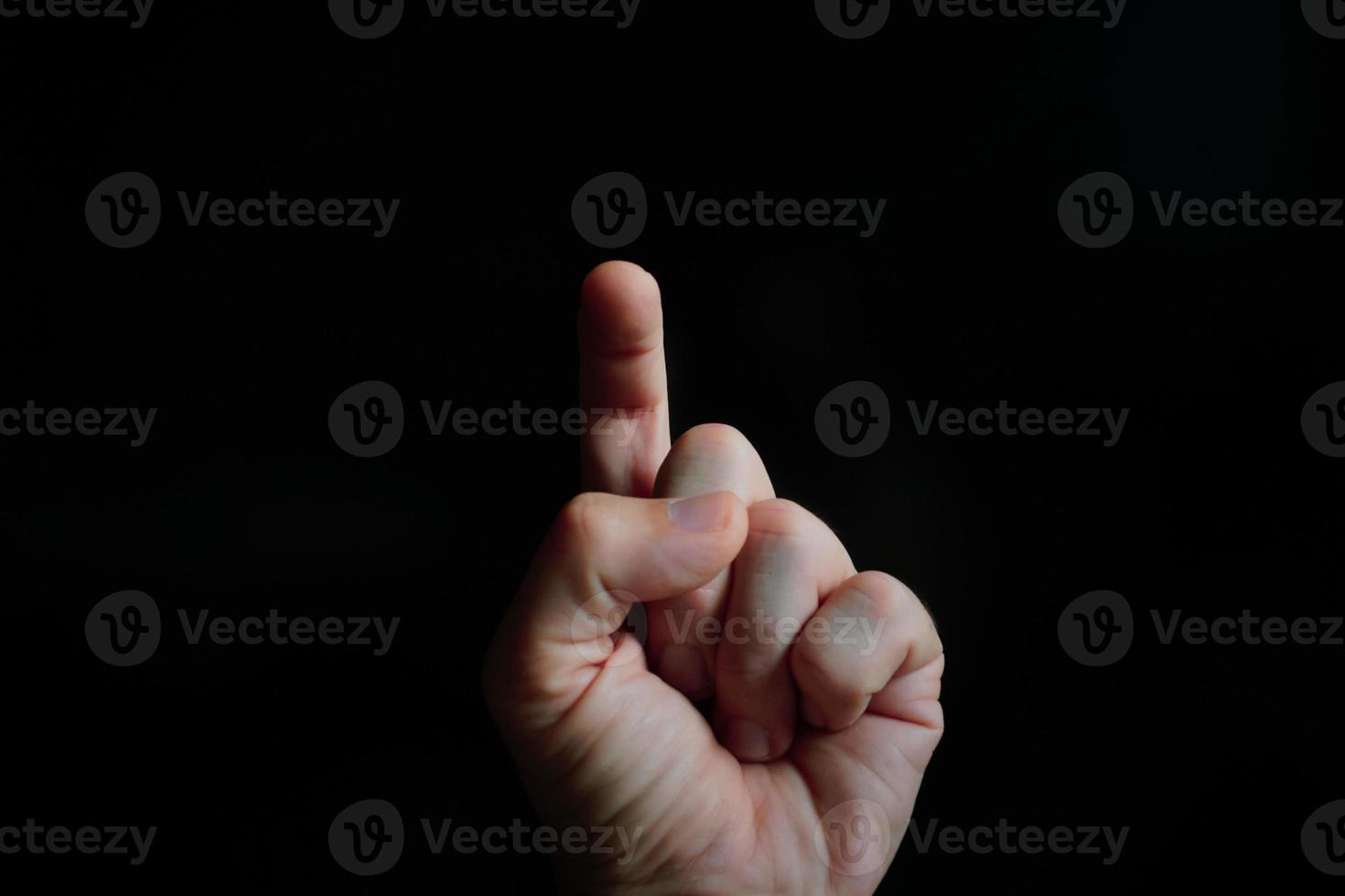 index finger pointing at the screen, black background photo