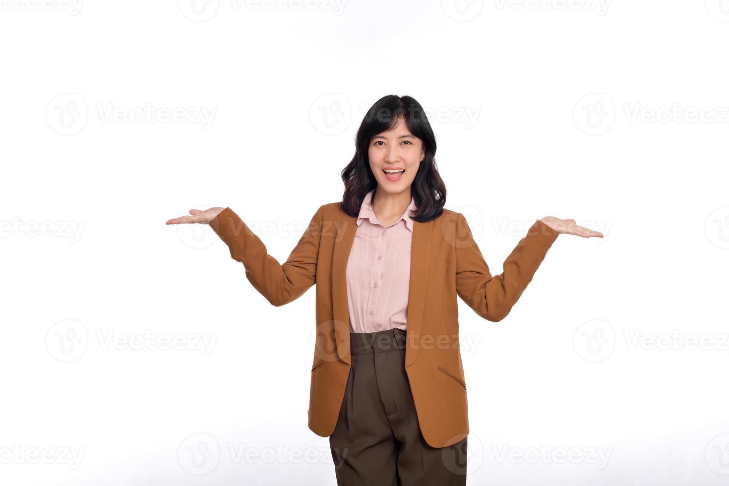 Young happy woman of Asian ethnicity wearing spread hands looking camera isolated on white background studio portrait. People lifestyle concept photo