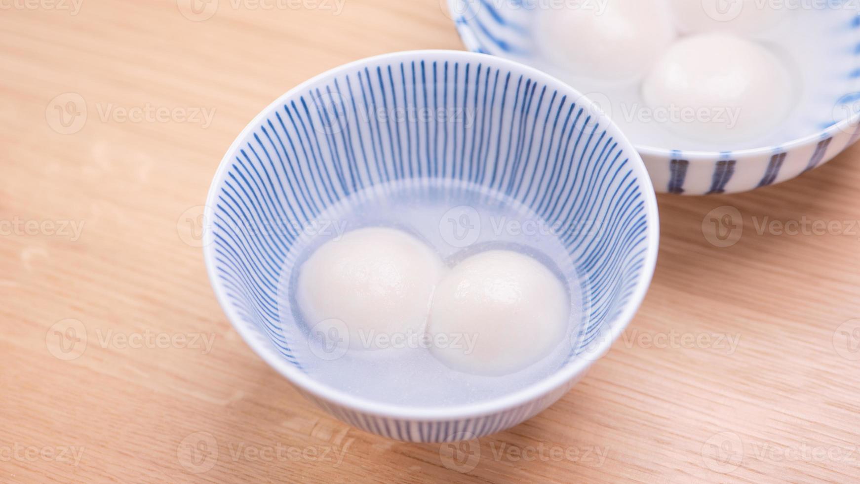Tang yuan, tangyuan, yuanxiao in a small bowl. Delicious asian traditional festive food rice dumpling balls with stuffed fillings for Chinese Lantern Festival, close up. photo