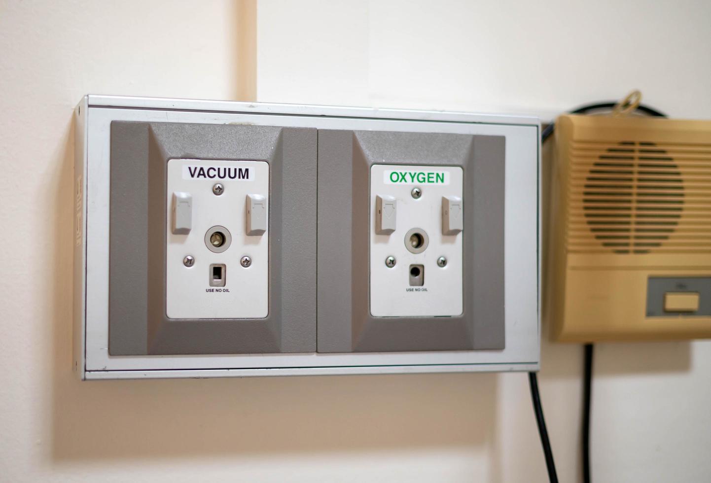 Close up of medical equipment, oxygen gas supply and vacuum on a wall at the hospital ward. photo