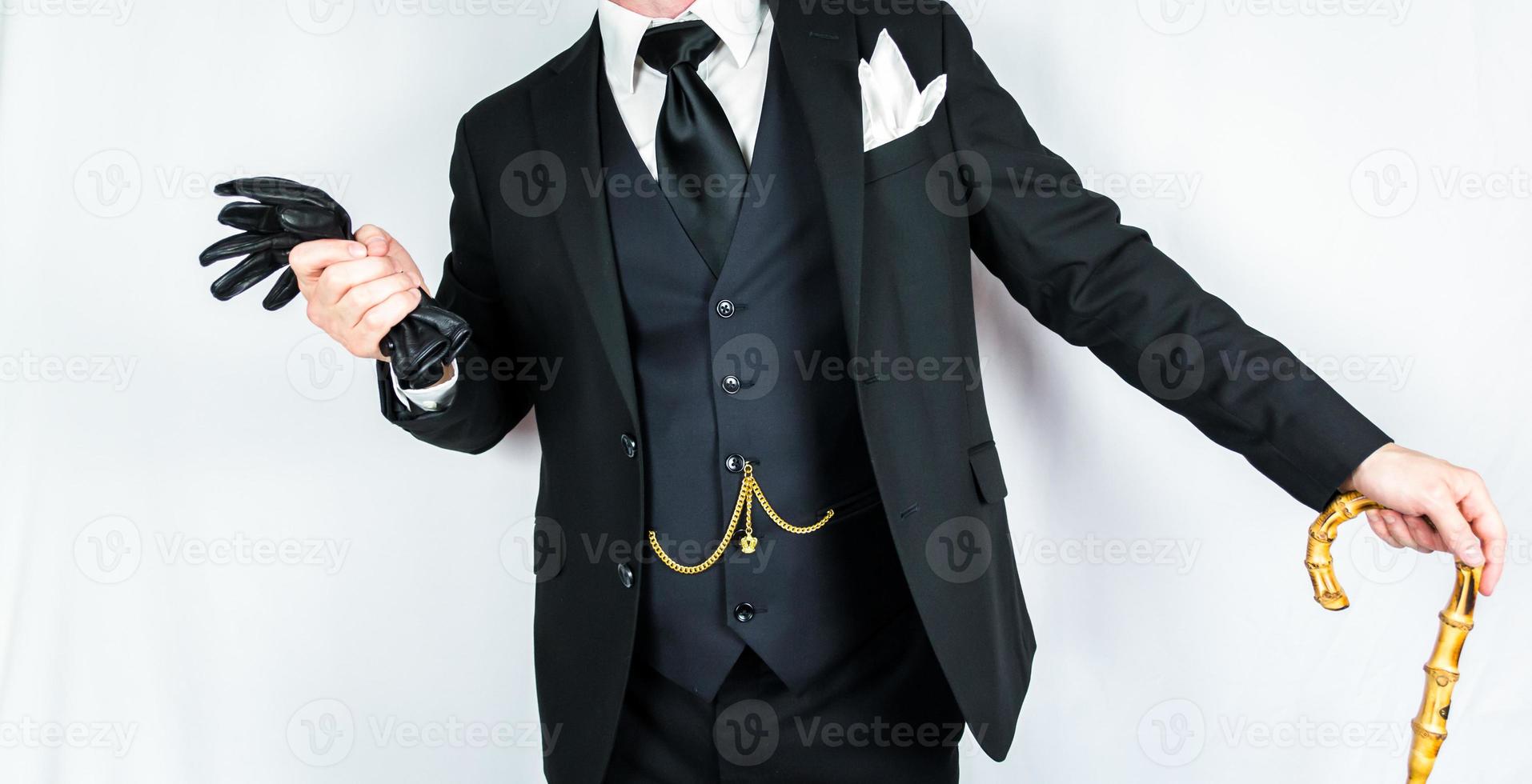 Portrait of Gentleman in Dark Suit Leaning on Umbrella on White Background. Vintage Style and Retro Fashion. photo