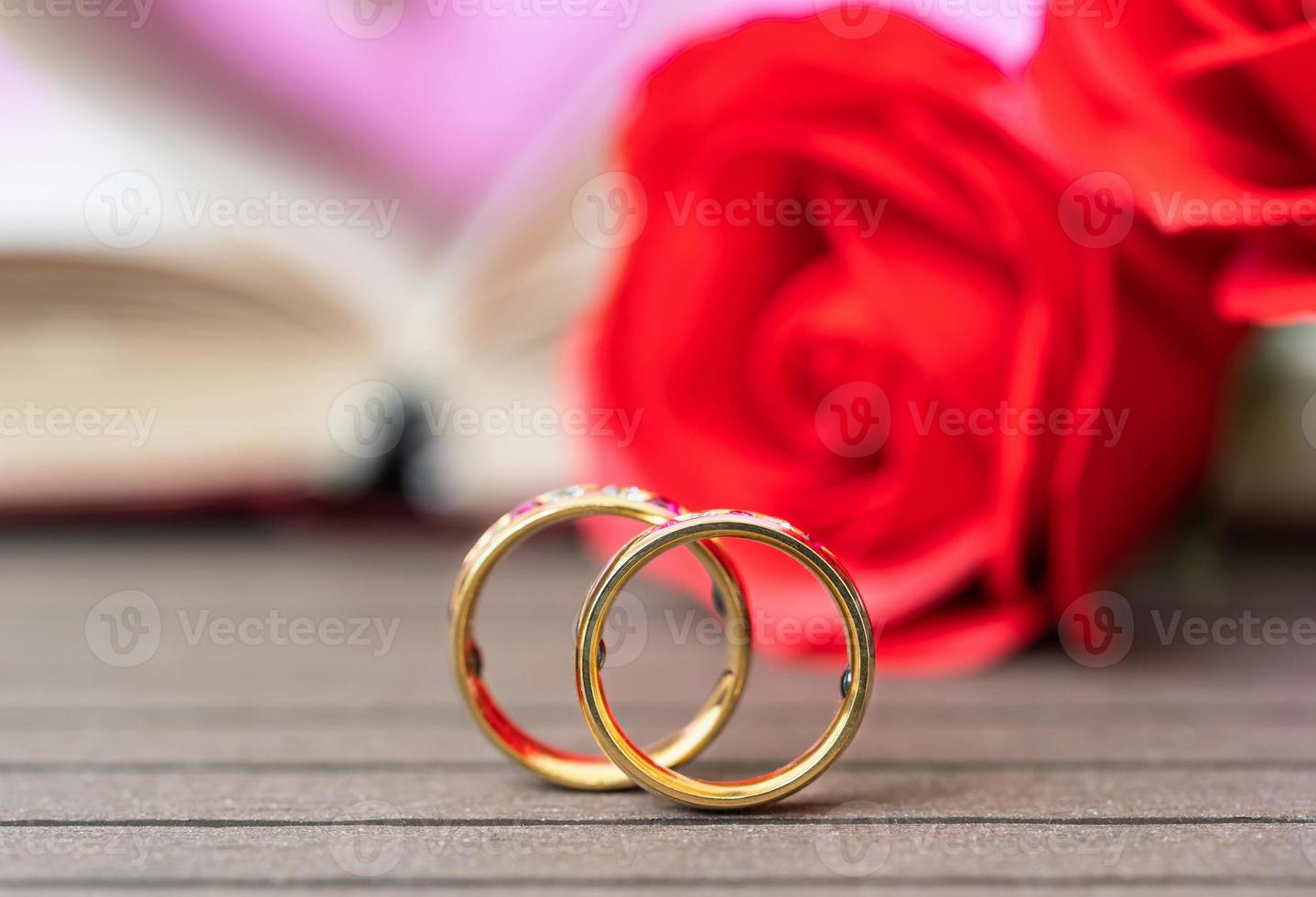 Close up wedding ring and red rose photo